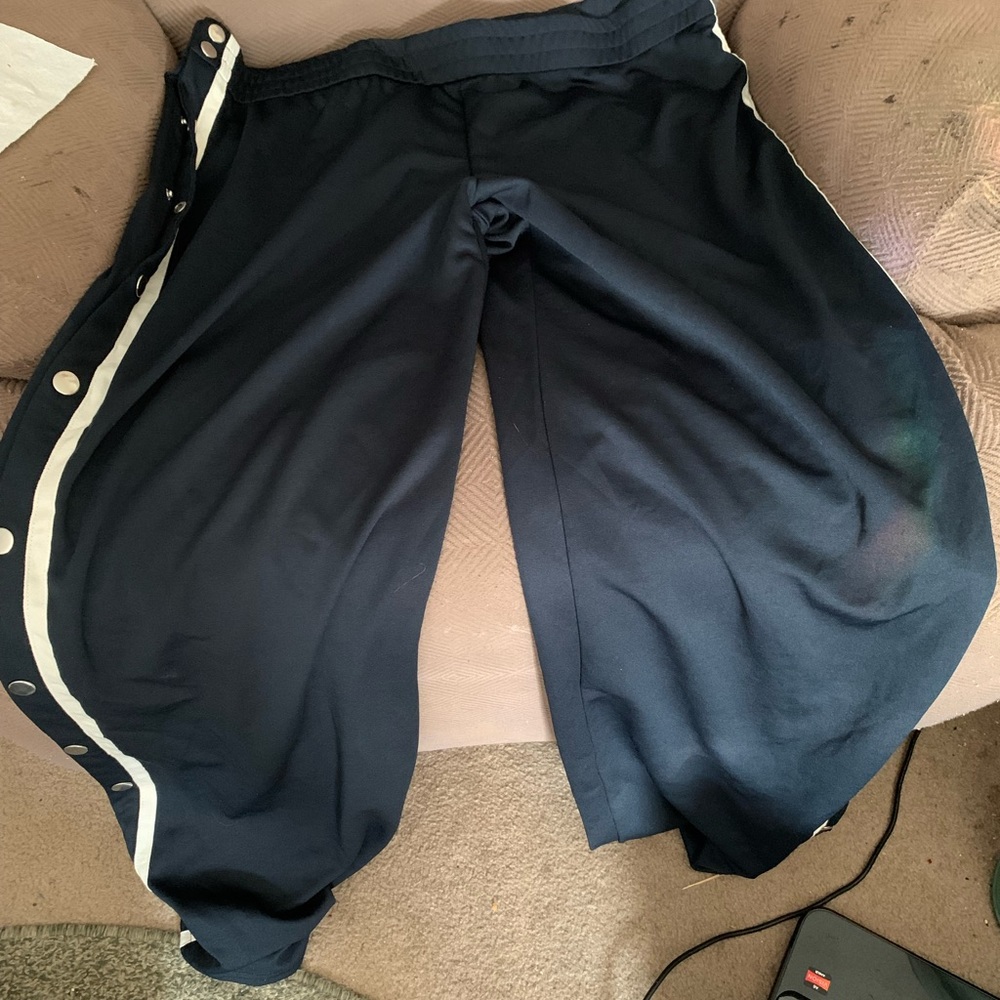 Track pants with buttons down each leg